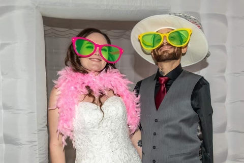 Antonio and his wife at their wedding with fun oversized sunglasses